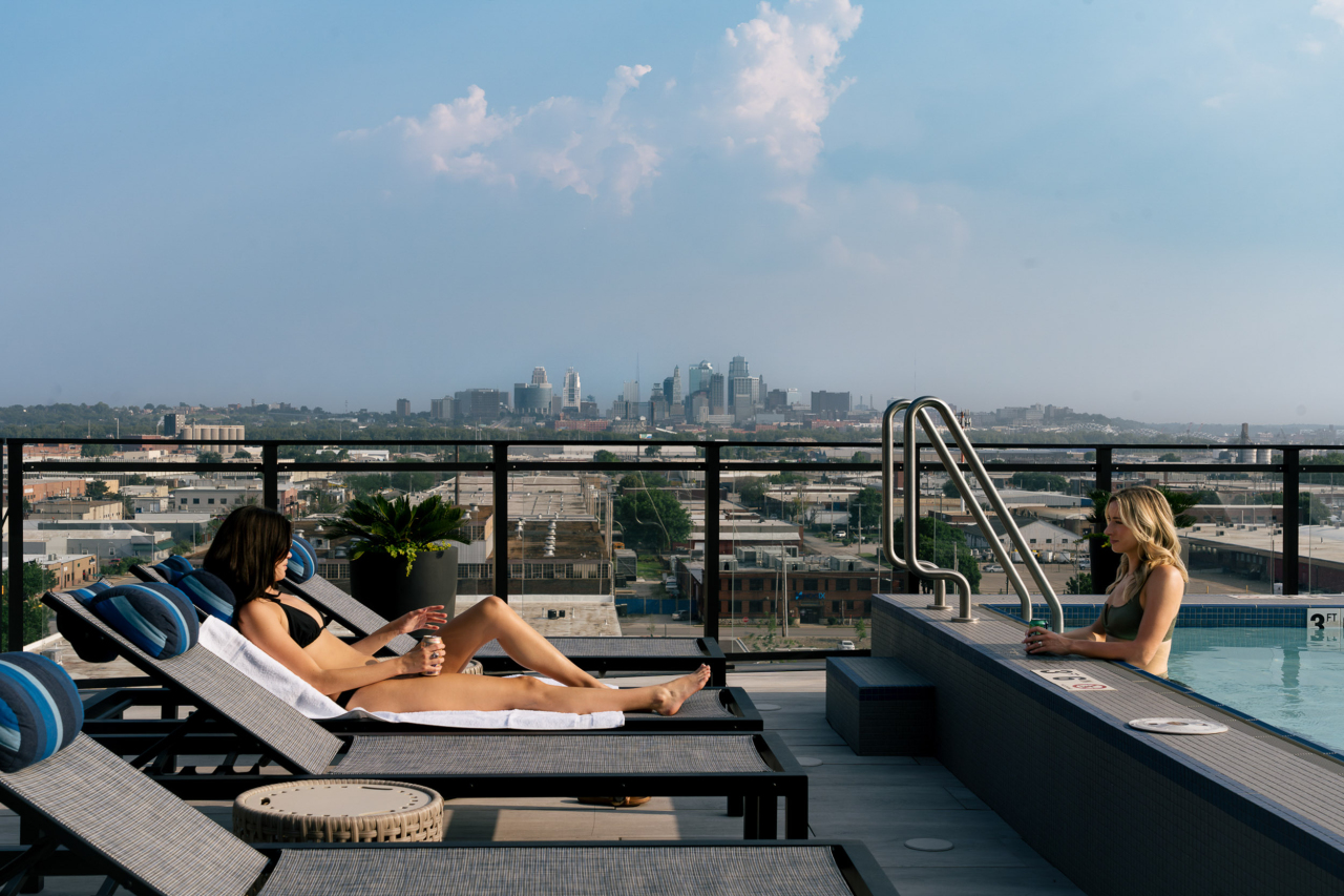 two people poolside at the oxbow rentals in north kansas city